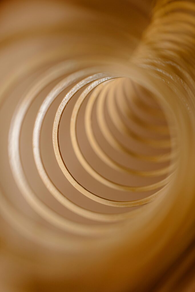 Close-up abstract image of golden spirals creating a tunnel effect.